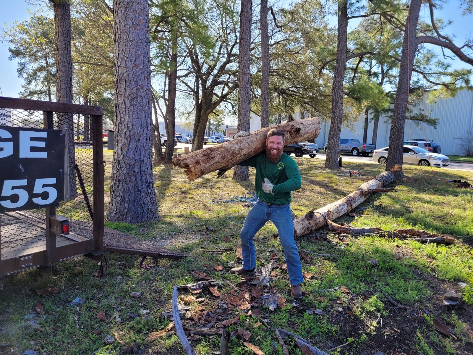 Cut 'N Edge Trees crew carrying a log off a Friendswood job site